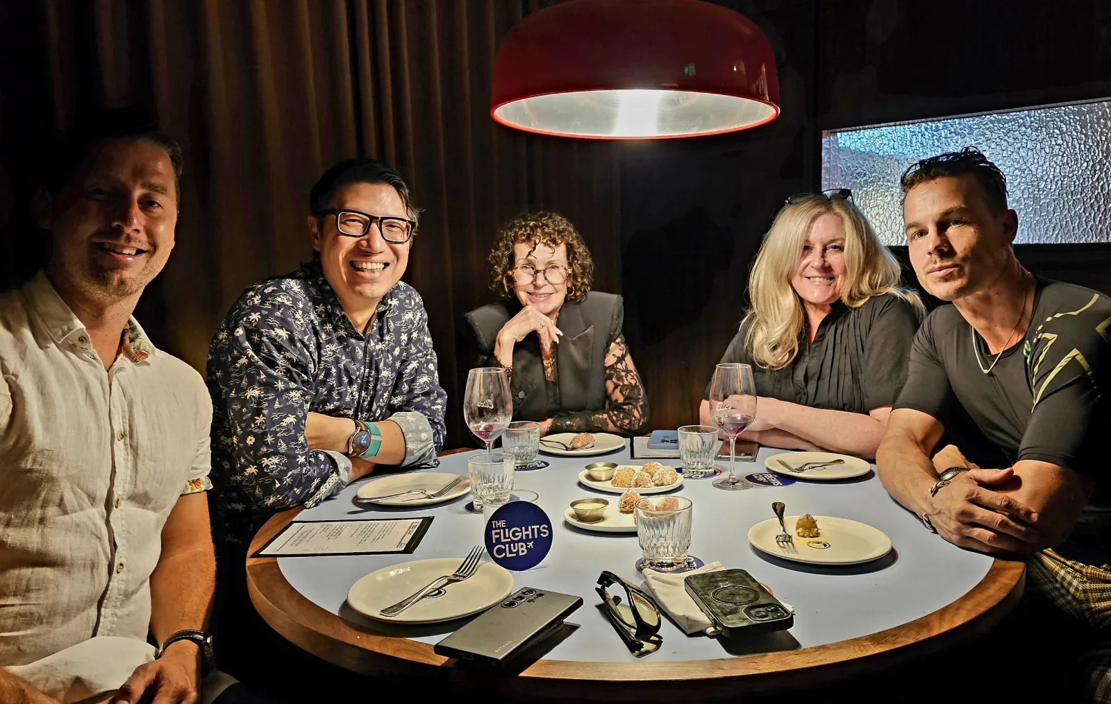 Melbourne Members' Dinner — round table of six members at a fine-dining wine bar in Melbourne, with a visible Flights Club coaster on the table.