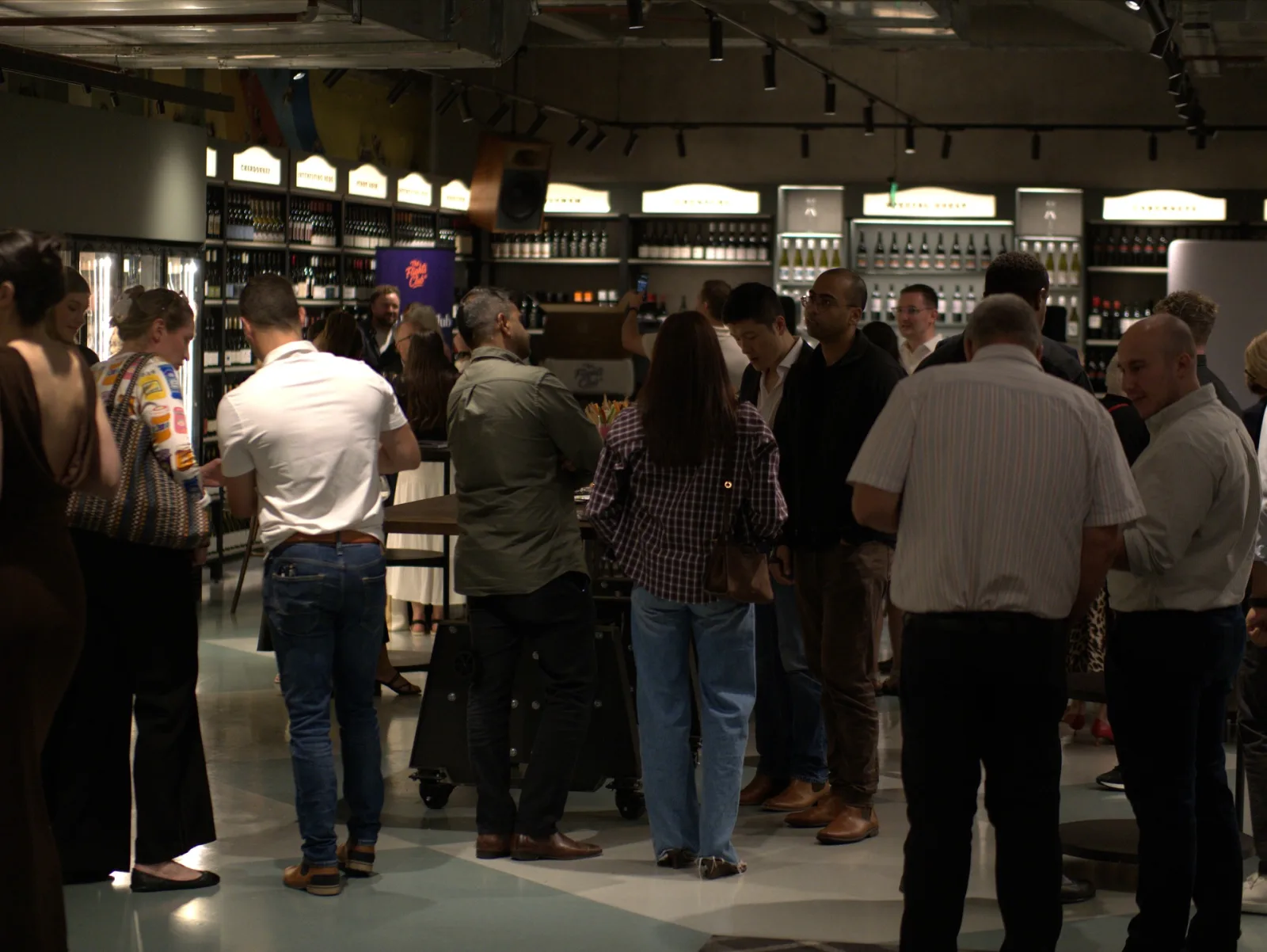 Members' Wine Evening — Flights Club members mingling and chatting at a curated wine event.