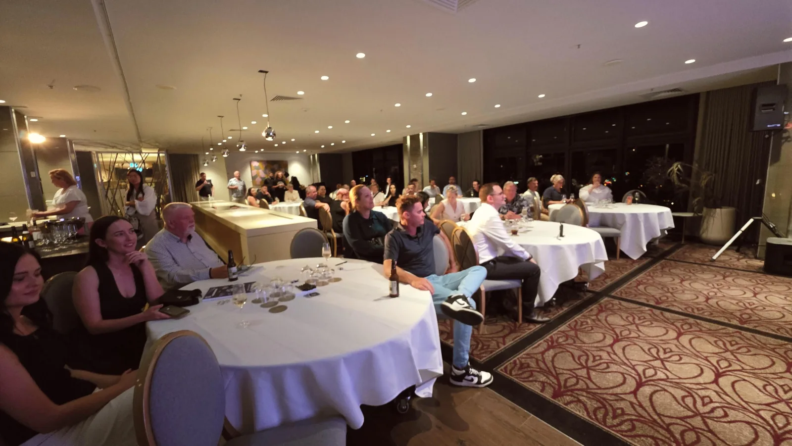 Brisbane Roadshow — members seated at white-linen round tables in a hotel ballroom event.