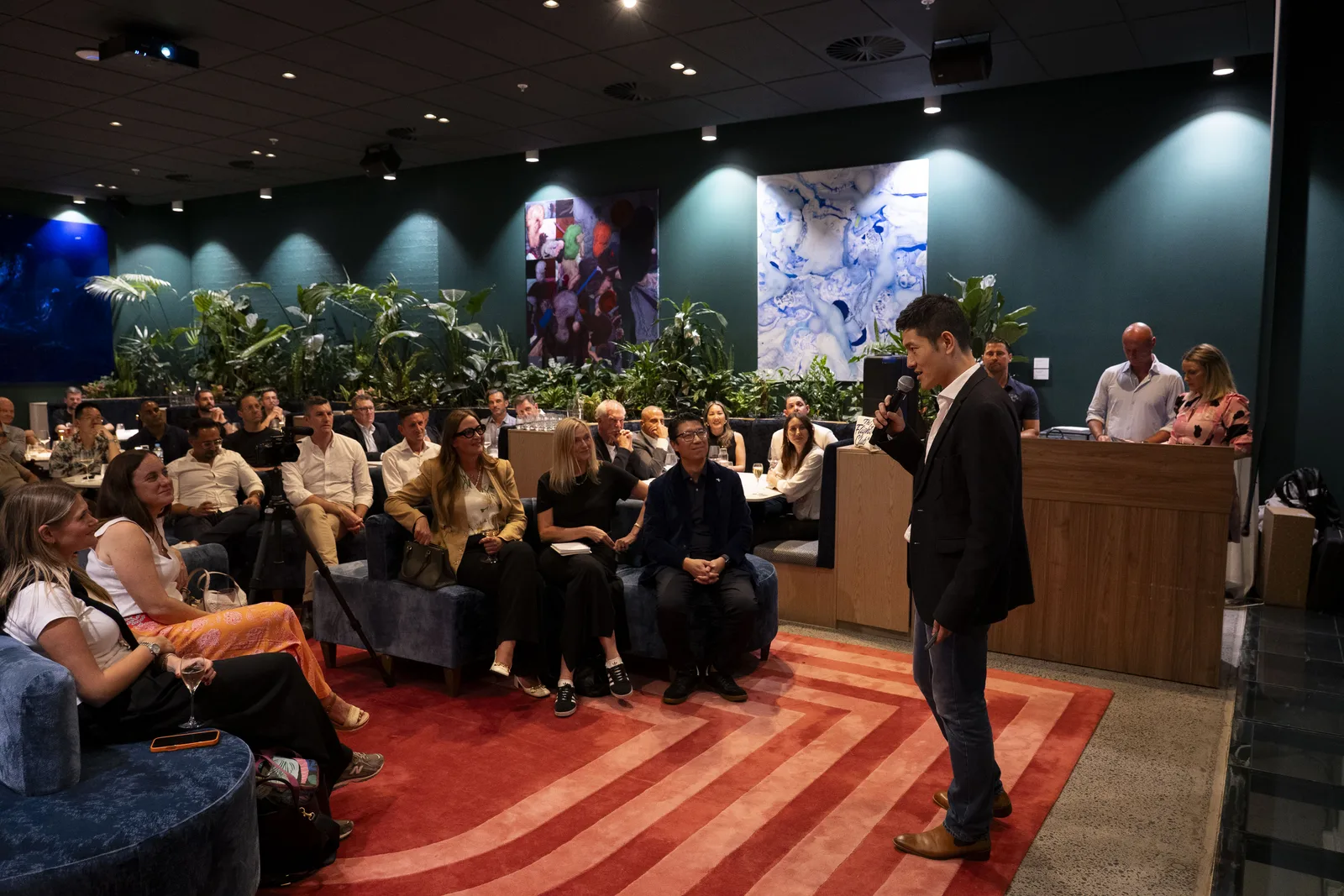 Sydney Roadshow — Flights Club members seated in a designer event room watching the presenter speak.