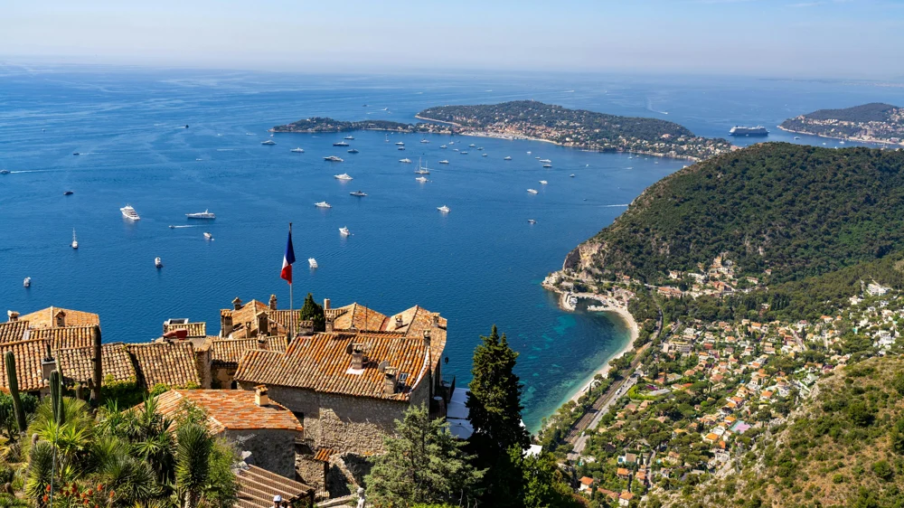 Terracotta rooftops and sailing boats along the French Riviera